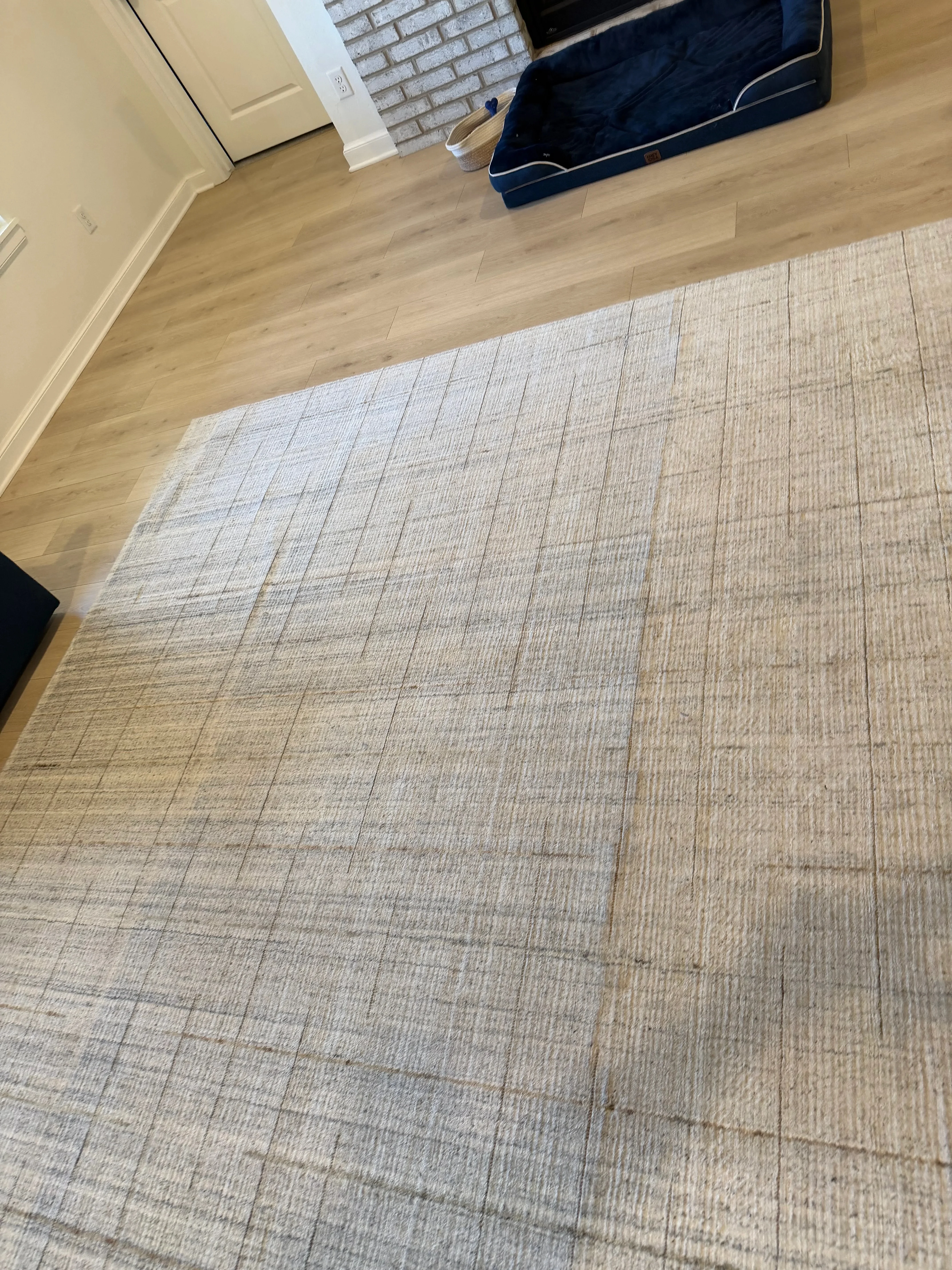 Clean light beige textured carpet with grid pattern in residential room