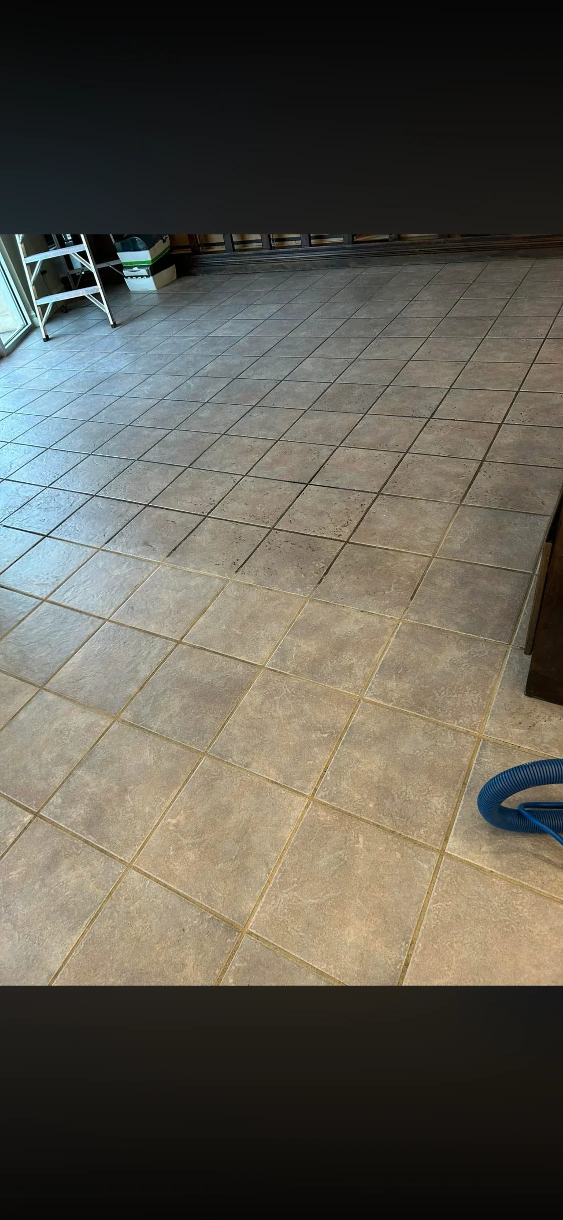 Clean ceramic tile floor with diagonal grout lines in neutral stone tones